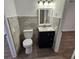 Bathroom with toilet, vanity, and wood-look floors at 1503 33Rd Nw St, Winter Haven, FL 33881