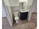 Bathroom with toilet, vanity, and wood-look floors at 1503 33Rd Nw St, Winter Haven, FL 33881