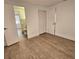 Bedroom with wood-look floors and access to bathroom at 1503 33Rd Nw St, Winter Haven, FL 33881