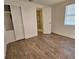Bedroom with wood-look floors and access to a bathroom at 1503 33Rd Nw St, Winter Haven, FL 33881