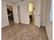 Spacious bedroom with wood-look floors and access to a bathroom and kitchen at 1503 33Rd Nw St, Winter Haven, FL 33881