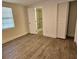 Bedroom with wood-look floors and en-suite bathroom at 1503 33Rd Nw St, Winter Haven, FL 33881