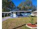 Newly renovated blue house with a landscaped front yard at 1503 33Rd Nw St, Winter Haven, FL 33881