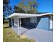 Newly painted house exterior with carport and landscaped yard at 1503 33Rd Nw St, Winter Haven, FL 33881