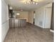 Open concept living room and kitchen with modern wood-look floors at 1503 33Rd Nw St, Winter Haven, FL 33881