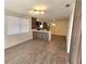 Open concept living room and kitchen with modern wood-look floors at 1503 33Rd Nw St, Winter Haven, FL 33881