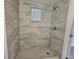 Walk-in shower with tile surround and window at 1503 33Rd Nw St, Winter Haven, FL 33881