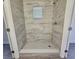 Walk-in shower with tile surround and window at 1503 33Rd Nw St, Winter Haven, FL 33881