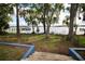 Steps lead down to a tranquil waterfront with a dock and boat at 154 Lago Vista Blvd, Casselberry, FL 32707