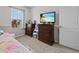 Bright bedroom featuring a TV, dresser, and window coverings at 159 Auburn Grove Blvd, Auburndale, FL 33823