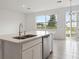 Kitchen island with double sink, quartz countertop, and stainless steel dishwasher at 1609 Pelican Dr, Davenport, FL 33896