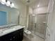 Bathroom with granite countertop, toilet, and shower at 16230 Trinidad Way, Clermont, FL 34714