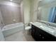Bathroom with tub, toilet, vanity with granite countertop at 16230 Trinidad Way, Clermont, FL 34714