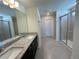 Modern bathroom with granite countertop and walk-in shower at 16230 Trinidad Way, Clermont, FL 34714