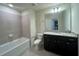 Bathroom with tub, toilet, vanity with granite countertop at 16230 Trinidad Way, Clermont, FL 34714
