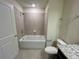Modern bathroom with a shower/tub combo and tile surround at 16230 Trinidad Way, Clermont, FL 34714