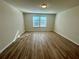 Spacious bedroom with wood-look floors and dual windows at 16230 Trinidad Way, Clermont, FL 34714