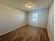 Bright bedroom with wood-look floors and a window at 16230 Trinidad Way, Clermont, FL 34714