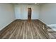 Bright bedroom with wood flooring and access to bathroom at 16230 Trinidad Way, Clermont, FL 34714