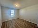 Bright bedroom with wood-look floors and a window at 16230 Trinidad Way, Clermont, FL 34714