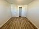 Bedroom with wood-look floors, closet and neutral walls at 16230 Trinidad Way, Clermont, FL 34714