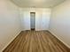 Bedroom with wood-look floors, closet and neutral walls at 16230 Trinidad Way, Clermont, FL 34714