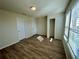 Well-lit bedroom with wood-look floors and ample closet space at 16230 Trinidad Way, Clermont, FL 34714