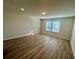 Sunlit bedroom showcasing wood-look floors and a neutral color scheme at 16230 Trinidad Way, Clermont, FL 34714
