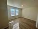 Bright bedroom with wood-look floors and large windows at 16230 Trinidad Way, Clermont, FL 34714