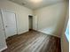 Spacious bedroom with wood laminate floors and closet at 16230 Trinidad Way, Clermont, FL 34714