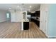 Open concept living area with wood-look floors at 16230 Trinidad Way, Clermont, FL 34714