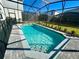 Inviting screened-in pool with paved deck at 16230 Trinidad Way, Clermont, FL 34714