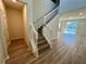 Modern staircase with white railings and laminate flooring at 16230 Trinidad Way, Clermont, FL 34714