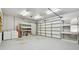 Garage with large door, shelving, and space for a workbench at 2141 Camellia Dr, Longwood, FL 32779