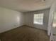Bedroom with carpeted floor and window, access to bathroom at 2355 Cypress Rd, Deland, FL 32724