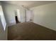Carpeted bedroom with window and access to other rooms at 2355 Cypress Rd, Deland, FL 32724