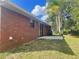 Brick house back view, with a patio and grassy backyard at 2355 Cypress Rd, Deland, FL 32724