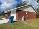 Brick house side view, showing the garage and utility area at 2355 Cypress Rd, Deland, FL 32724