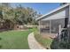 Landscaped backyard with a path leading to a screened porch at 2812 Summer Brooke Way, Casselberry, FL 32707