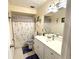 Bathroom with a shower/tub combo, white vanity, and dragonfly-patterned shower curtain at 310 Duke Ave, Altamonte Springs, FL 32714