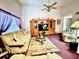 Living room with purple carpet, ceiling fan, and entertainment center at 310 Duke Ave, Altamonte Springs, FL 32714