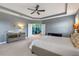 Bright main bedroom with large bed, sitting area and access to bathroom at 32004 Redtail Reserve Blvd, Sorrento, FL 32776