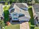Two-story house, gray exterior, blue shutters, brick driveway, landscaped yard at 3207 Stratton Cir, Kissimmee, FL 34744