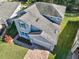 Two-story house with gray exterior, landscaped yard, and brick driveway, aerial view at 3207 Stratton Cir, Kissimmee, FL 34744