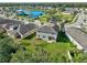 Aerial view of a two-story house with backyard and community amenities at 3207 Stratton Cir, Kissimmee, FL 34744