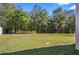 Large backyard with grassy area and mature trees at 3207 Stratton Cir, Kissimmee, FL 34744