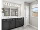 Double vanity bathroom with dark cabinets, quartz countertops and large mirror at 3207 Stratton Cir, Kissimmee, FL 34744