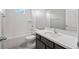 Bathroom with a bathtub, toilet and dark vanity at 3207 Stratton Cir, Kissimmee, FL 34744