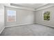Bright bedroom with grey carpet and neutral walls at 3207 Stratton Cir, Kissimmee, FL 34744