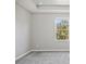 Simple bedroom with carpet, window, and neutral walls at 3207 Stratton Cir, Kissimmee, FL 34744
